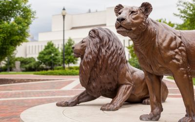Image of two Widener Pride statues with Wolfgram Memorial Library in the background.