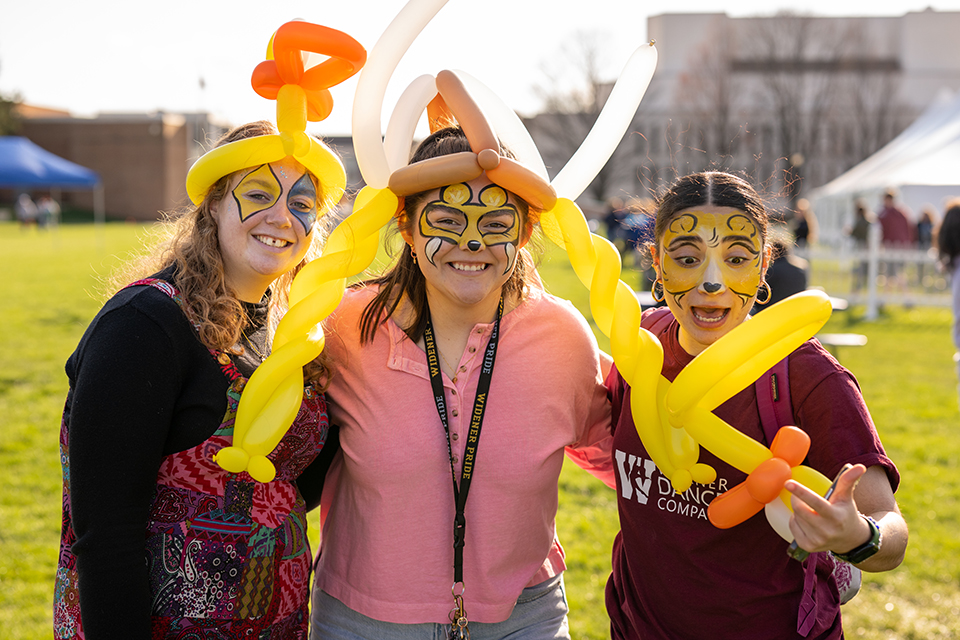 Children of alumni and staff enjoy balloon hats and face paintings at Pride a Palooza.