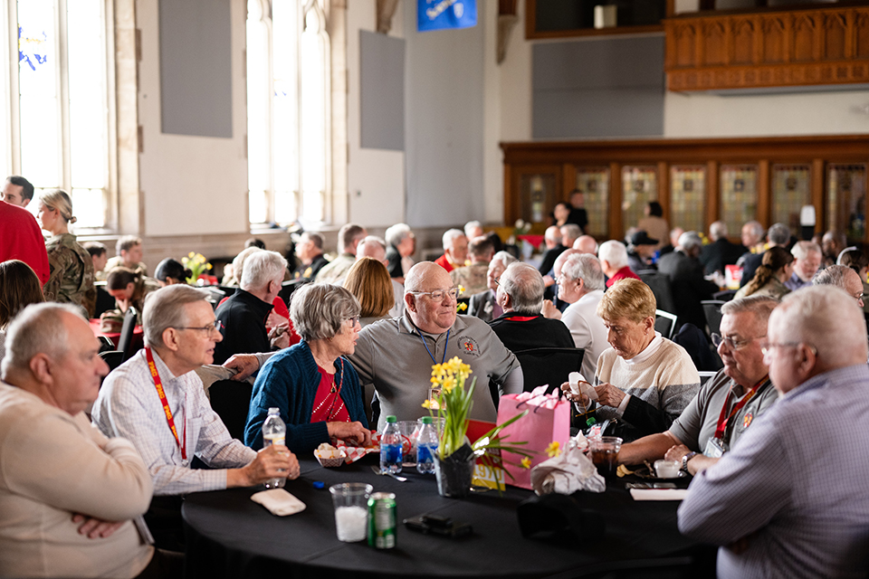 Lathem Hall is full of alumni sitting a tables during a Founders Day event.