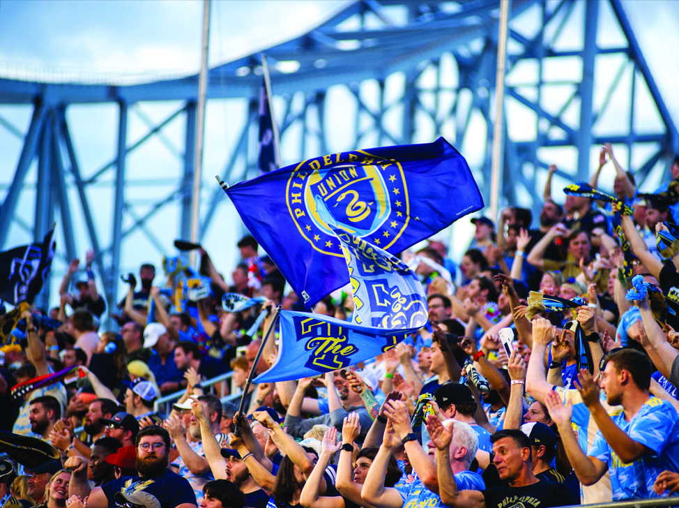 Union fans in the stadium seats cheering and waving flags