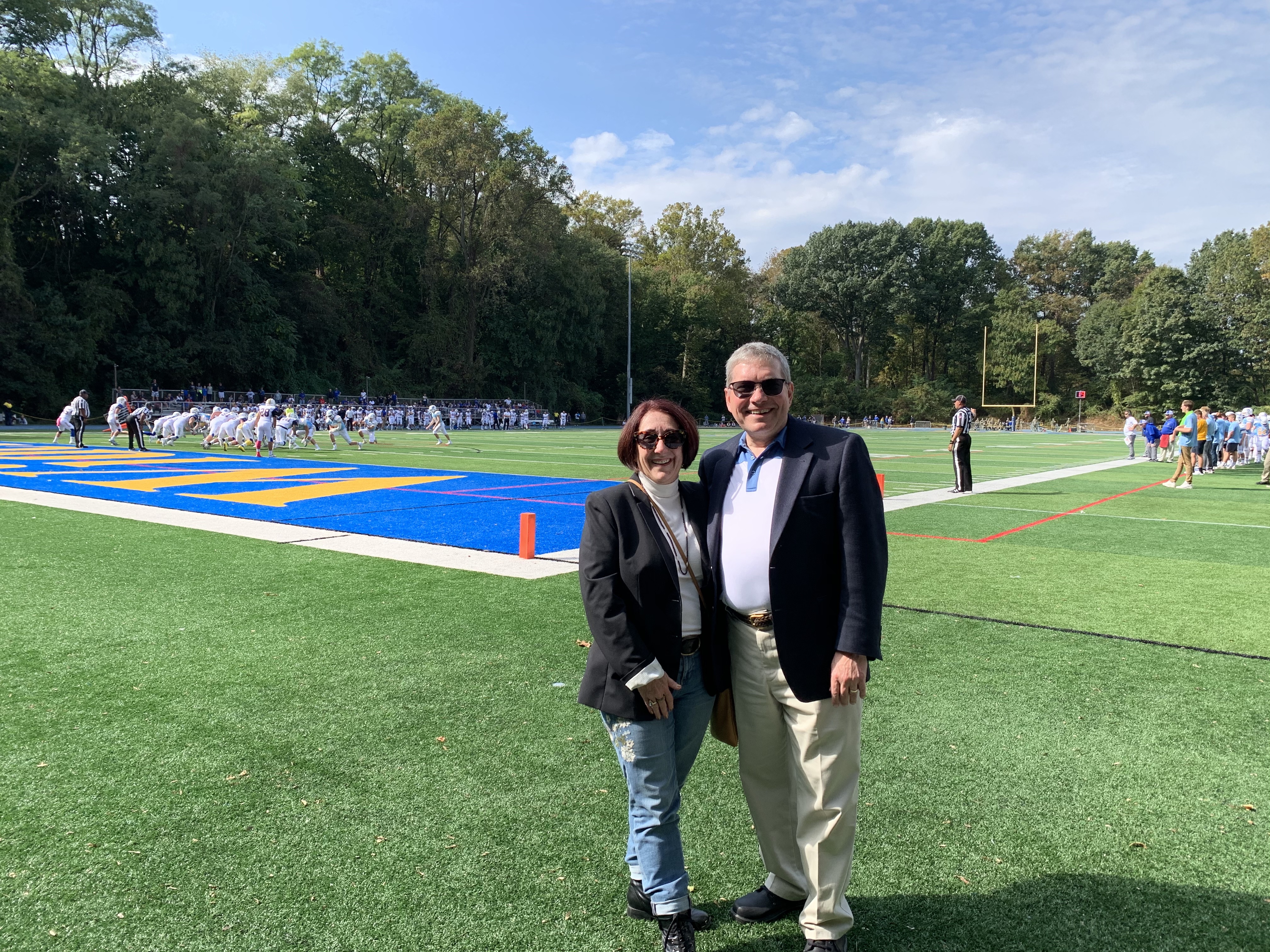 The Borinskis get in on the Widener football action on the field at homecoming.
