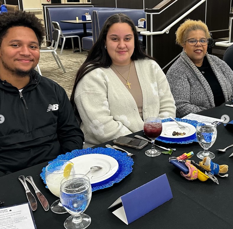 Two Widener Students and a faculty member seated at a table