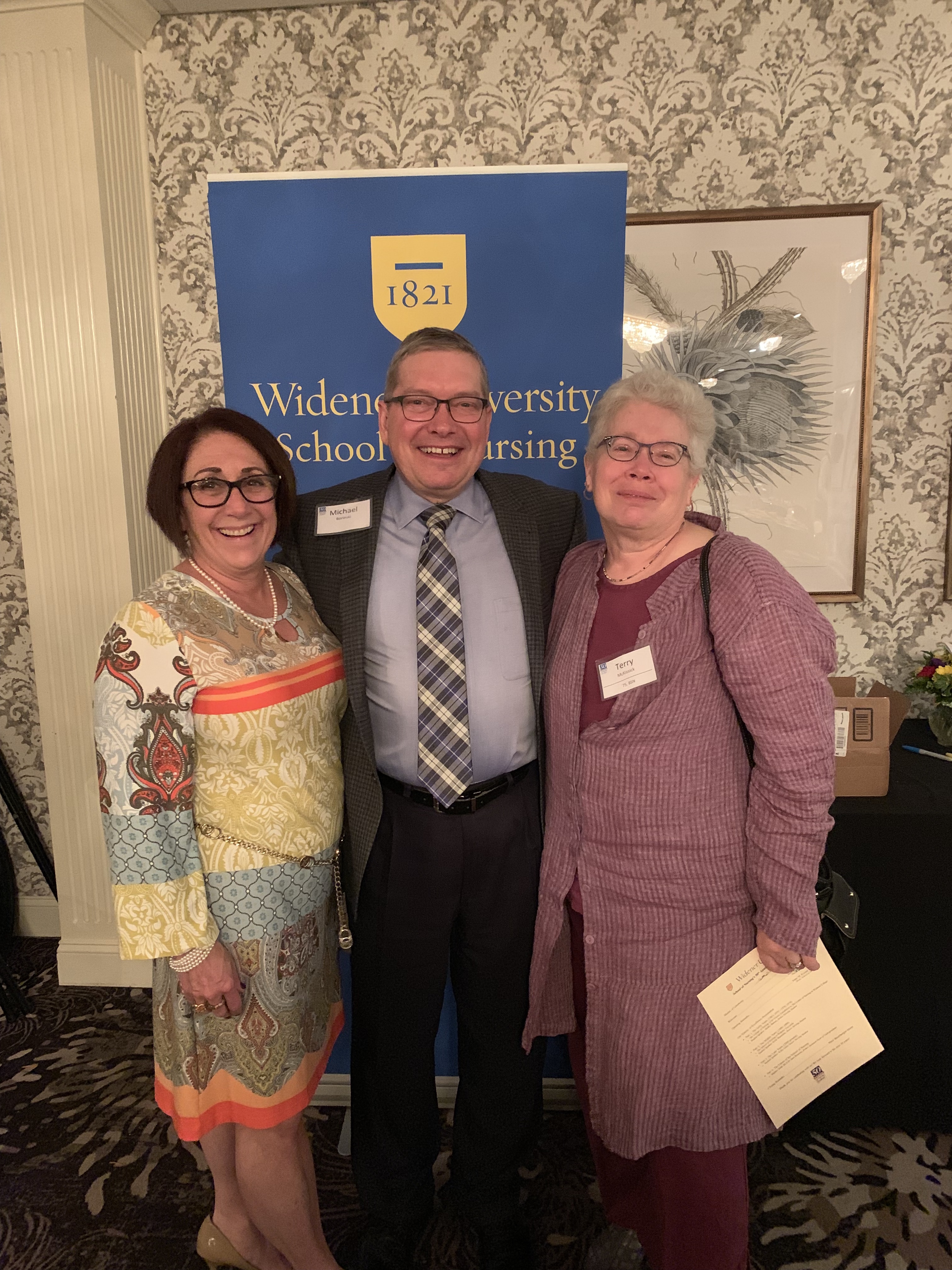 Marietta, Mike, and fellow alum Terry McKissick celebrate the School of Nursing 50 anniversary event in 2019.