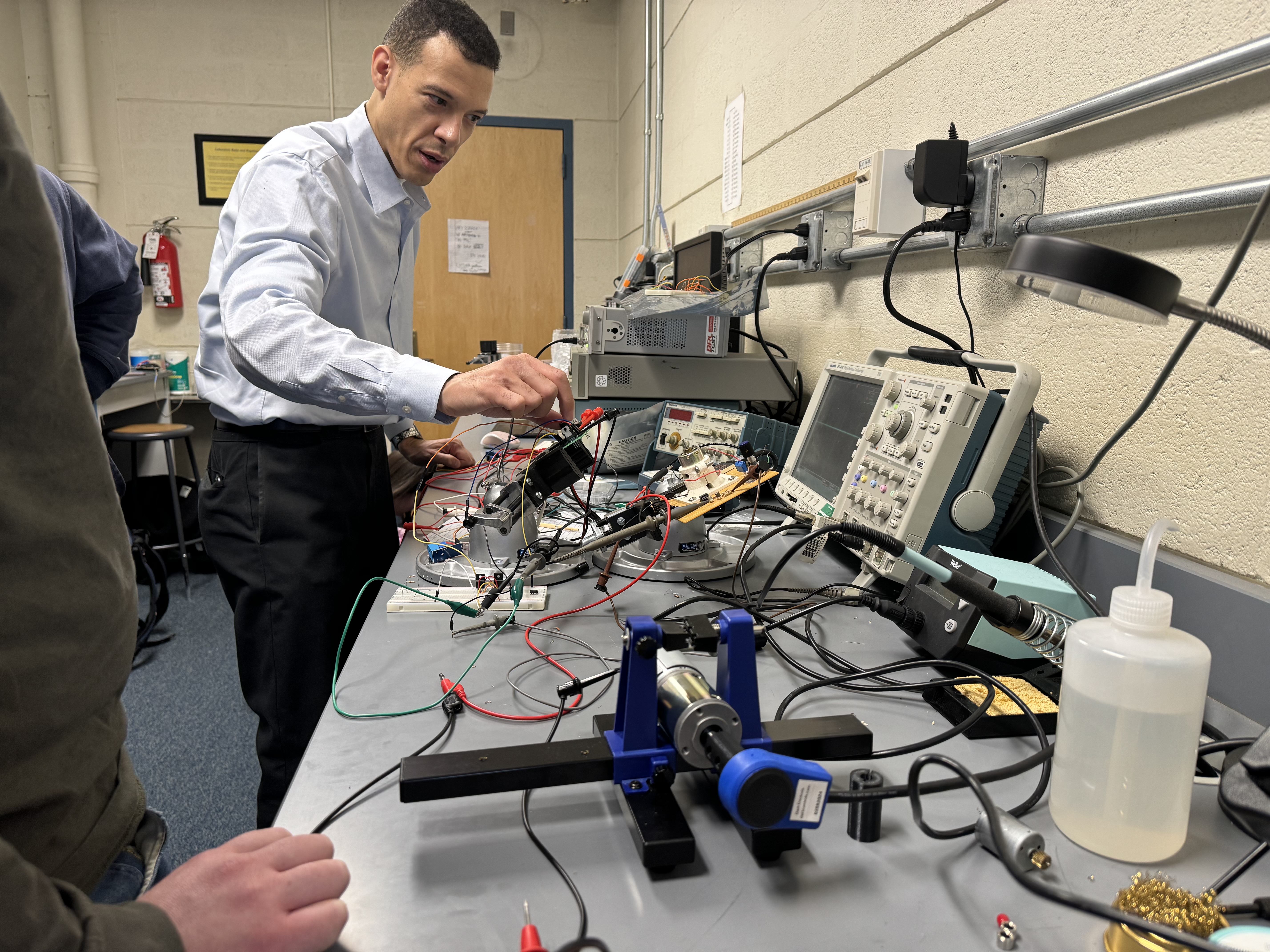 John Suarez working with electrical engineering student