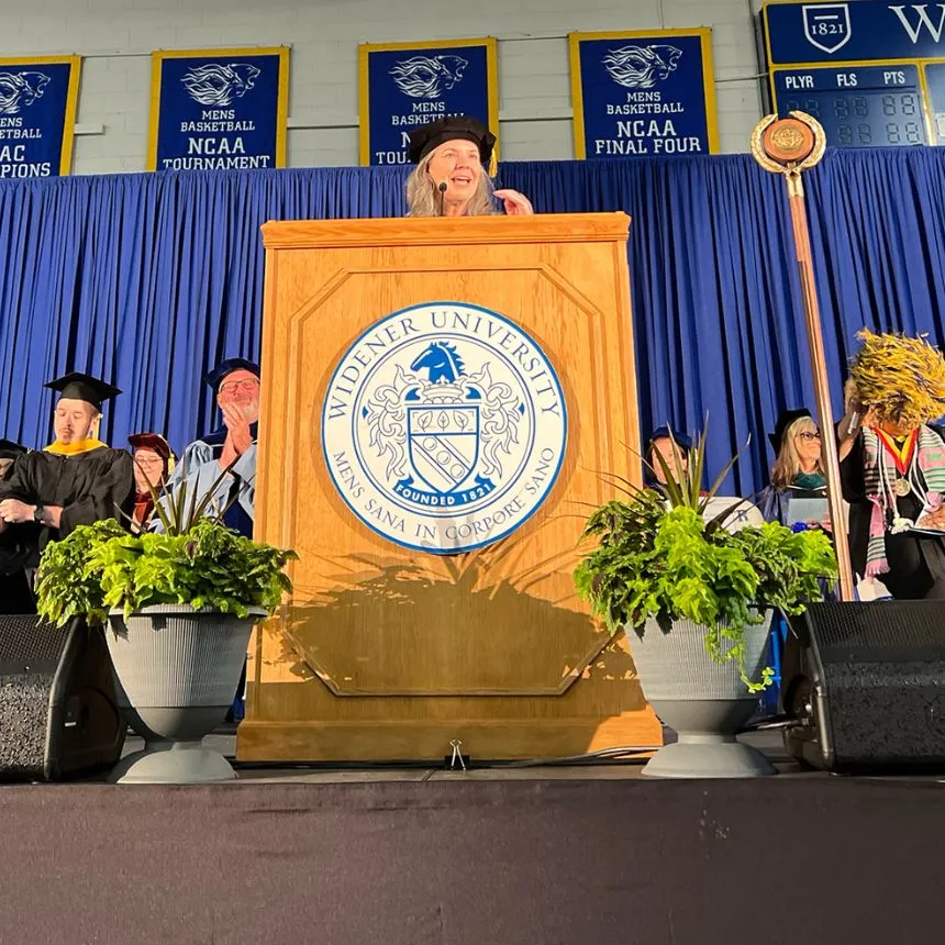 Stacey Robertson speaks to students at the podium during convocation.