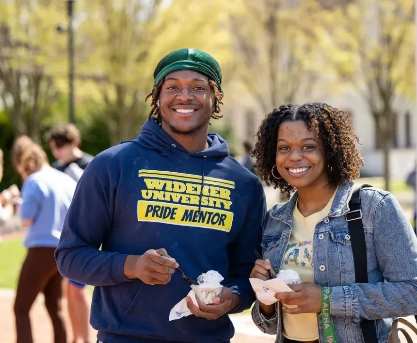Two students attend an outdoor ice cream social.