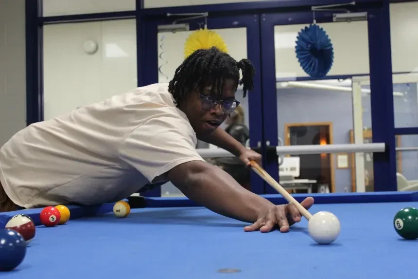 Student playing pool.