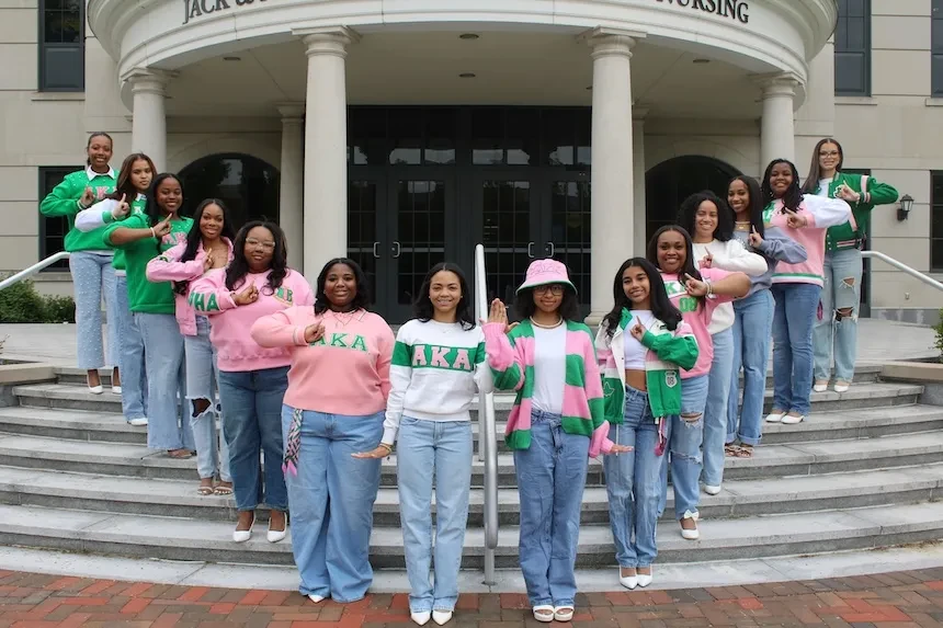 Members of Alpha Kappa Alpha Sorority, Inc. pose outside Widener University’s nursing building, showcasing sisterhood, leadership, and campus community.