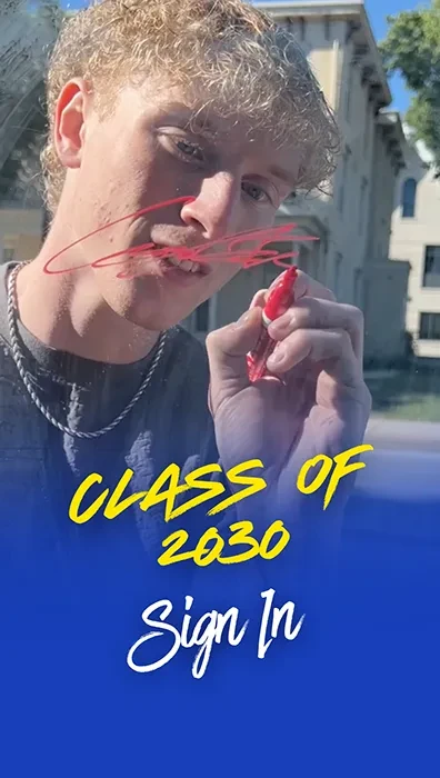 Incoming freshman signing his name on a glass; over the image is a blue filter and the words "Class of 2030 Sign In"