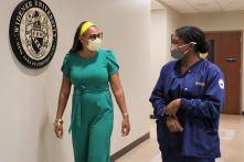 School of Nursing faculty Jawanza Bundy and a BSN degree nursing student walk the hallways