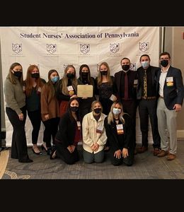 Nursing students pose at the SNAP convention holding the Chapter Excellence Award.