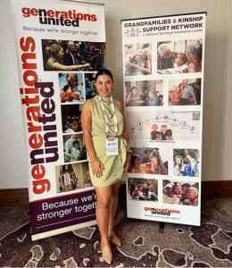 Jess Mereshensky '24 poses in front of conference banners