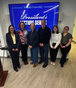 President Robertson standing with three faculty and two students at the event