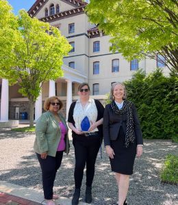 Micki Davis, President Stacey Robertson and Rebecca Ross standing outside Old Main