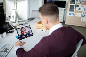 Adult student virtually meeting with a professor on a tablet