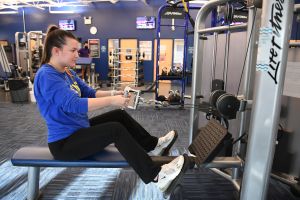 Student working out on a piece of equipment at Pride Recreation Center