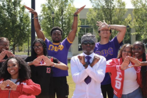 Students from Omega Psi Phi Fraternity and Delta Sigma Theta Sorority representing their organizations on campus.