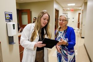widener school of nursing graduate faculty mentors doctoral nursing student wearing lab coat in office near philadelphia