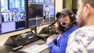 Communications major students operate cameras, audio, and production equipment in Widener University's TV studio control room.