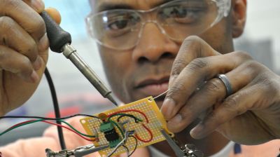 Student working towards their master's degree in electrical engineering gains hands-on experience in class. 