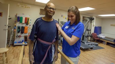 Pre-physical therapy student in clinic with client