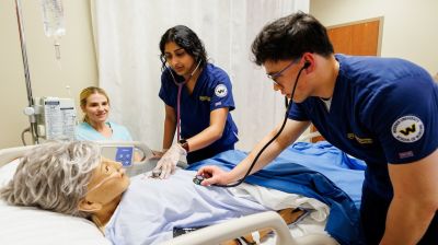 Two undergraduate nursing students in widener school of nursing bachelor of nursing (bsn) program work in simulation lab near philadelphia