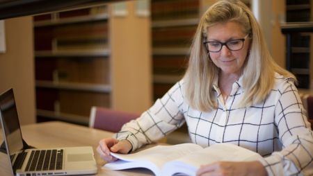 Graduate Student Studying in Library