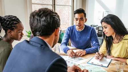 Diverse group of professionals in a meeting sitting at a table