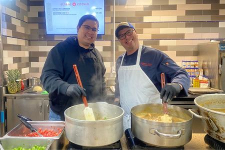 Bryan Lasso Bravo and Chef Matt serve students in the Pride Cafe.