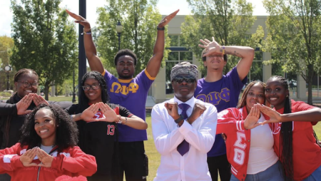 Students from Omega Psi Phi Fraternity and Delta Sigma Theta Sorority representing their organizations on campus.