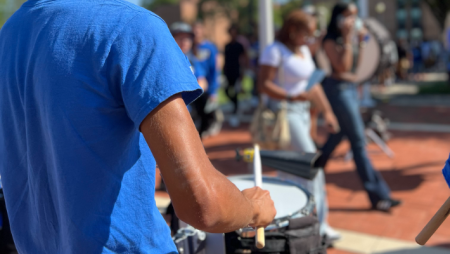 A band student plays in a drumline at Widener University.