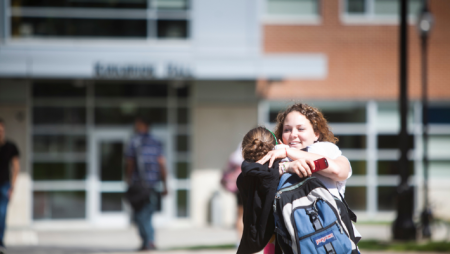 Students hug outside Kapelski Learning Center on Widener University' campus.