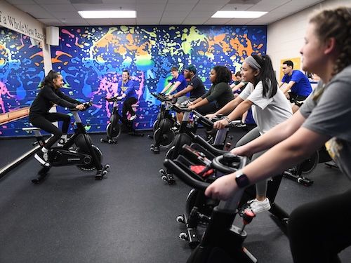 group of students at the pride rec partipating in group fitness cycling
