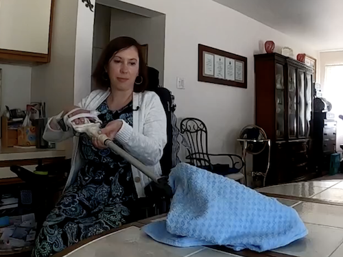 Mom using new robotic arm built by Widener occupational therapists.