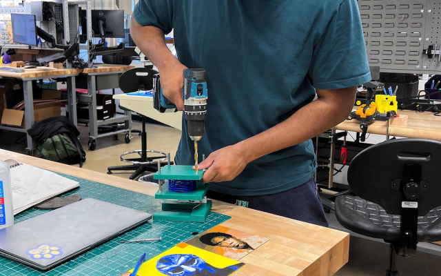 Student drilling a project within the Engineering Makerspace 